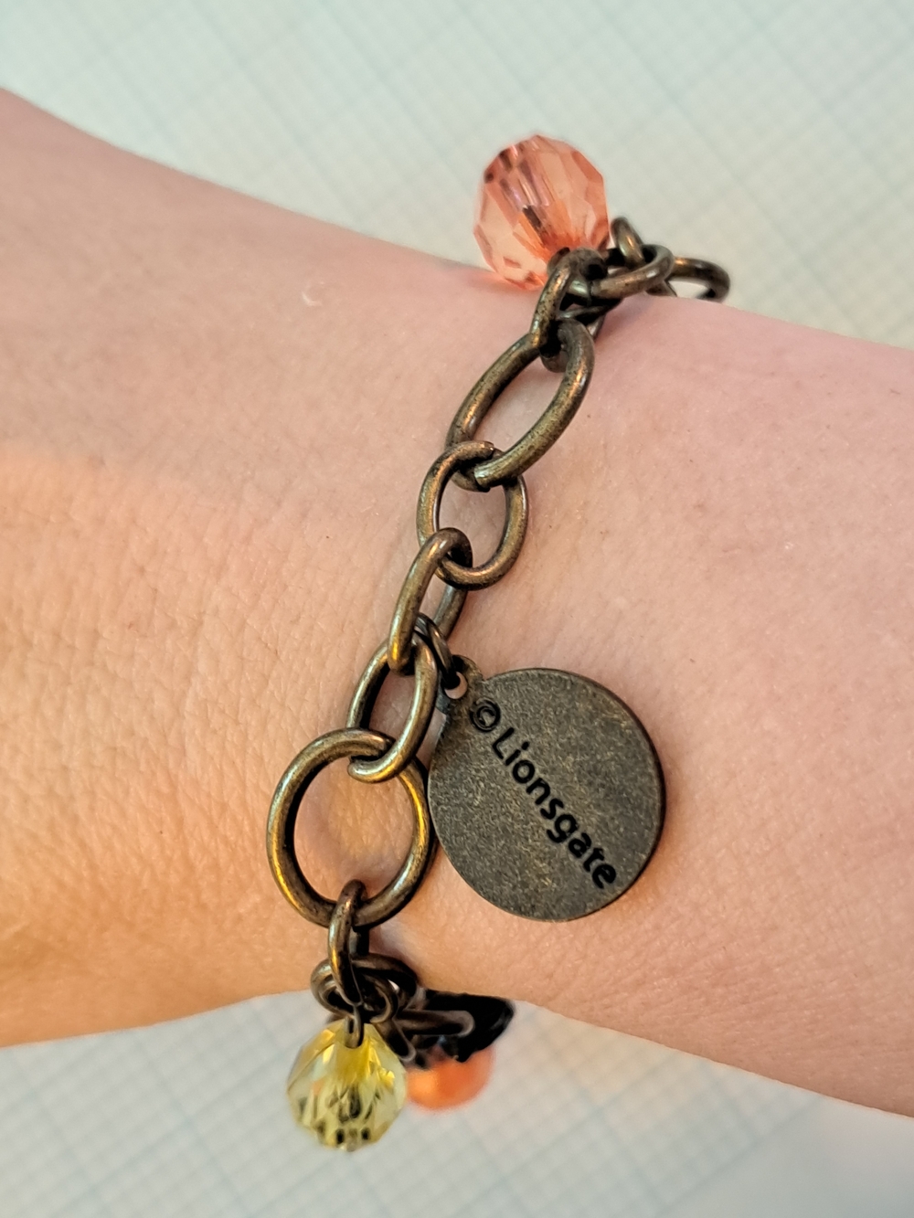 Lionsgate The Hunger Games Charm Bracelet with Peach and Yellow Beads